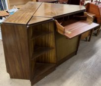 A mid 20th century teak three section corner unit, comprising a secretaire drawer, cupboards,