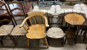 A smokers bow elbow chair together with a pair of ladder back dining chairs,