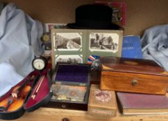 A miniature violin together with an inlaid box, correspondence, postcards, coins, geometry set, hat,