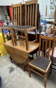 An oak gateleg dining table together with a set of four oak dining chairs and a standard lamp