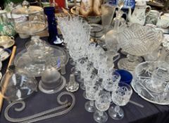 A glass cake stand and cover together with a section dish, drinking glasses,
