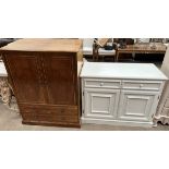 A cream side cabinet with two drawers and two cupboards on a plinth base together with a burr