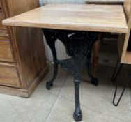 A cast iron pub table with a square top,