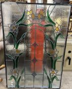 A double glazed stained glass window panel, decorated with daffodils,