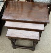 A nest of three oak tables