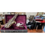 A Brass Corton Saxophone, cased together with a Pentax camera,