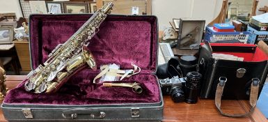A Brass Corton Saxophone, cased together with a Pentax camera,