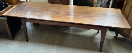 A mid 20th century teak coffee table with a rectangular top on tapering legs,