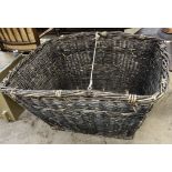 A large wicker log basket of rectangular form