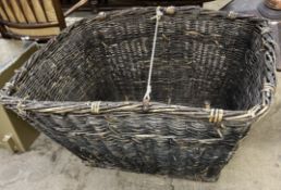 A large wicker log basket of rectangular form