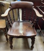 A smoker's bow elbow chair with a spindle back,
