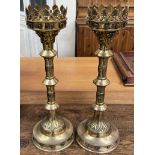 A pair of ecclesiastical brass candlesticks,