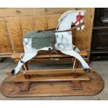 A small dapple grey rocking horse,