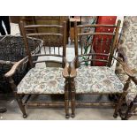 A pair of spindle back elbow chairs with pad upholstered seats on turned legs united by stretchers