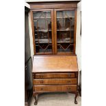 A 20th century mahogany bureau bookcase on cabriole legs with claw and ball feet,