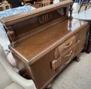 A 20th century oak sideboard with a raised back,