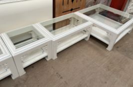 A set of five cream and blue painted glass topped coffee tables of varying sizes