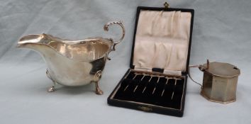 A George V silver sauce boat with a flared rim on pad feet, London,