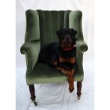 A Victorian porters chair with an upholstered back, arms and seats on turned legs and casters,