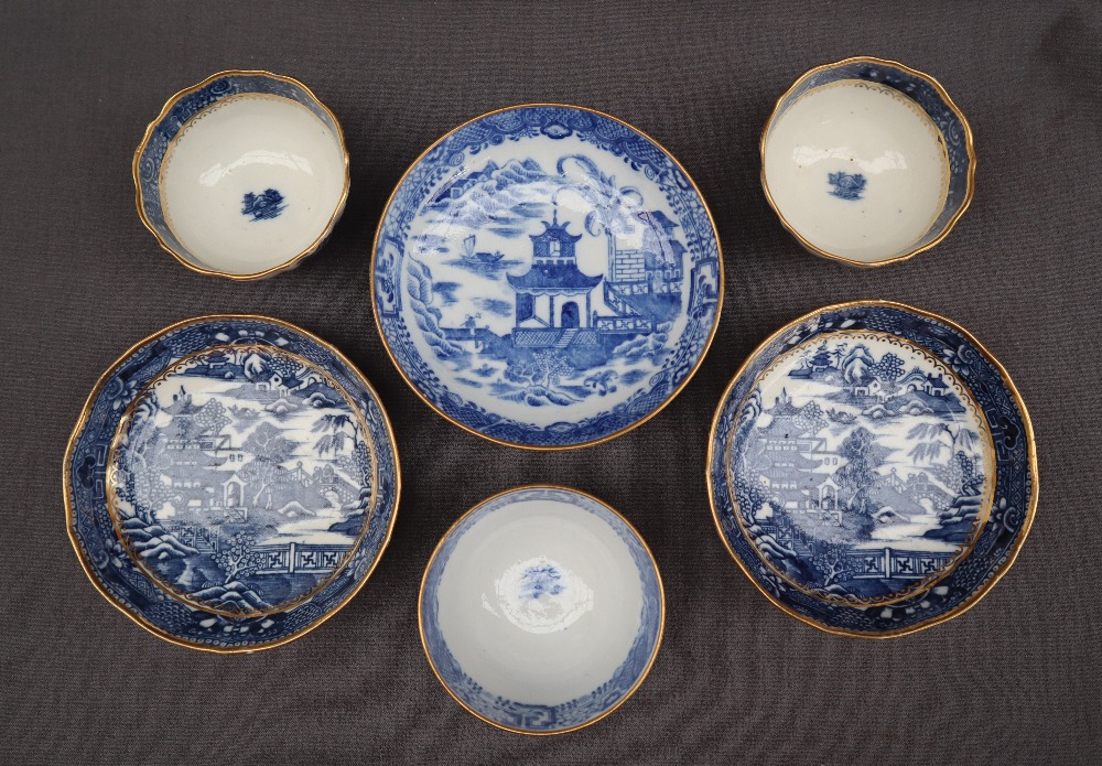 A pair of Salopian blue and white tea bowls and saucers transfer decorated in a variation of the