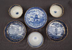 A pair of Salopian blue and white tea bowls and saucers transfer decorated in a variation of the