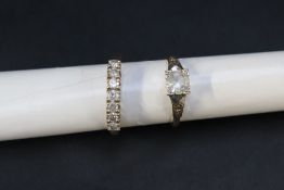 A seven stone diamond ring set with round old cut diamonds to an 18ct gold setting and shank,