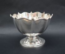 An Edward VII silver pedestal bowl, with a shaped rim and panelled body on a spreading foot,