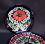 A Moorcroft pottery plate decorated with a poppy and leaves, impressed and painted marks dated 96,
