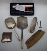 An Elizabeth II silver backed part dressing table set comprising a hand mirror,