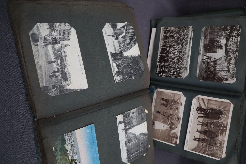 Two postcard albums comprising war related postcards, architecture, travel, comic, photographs,