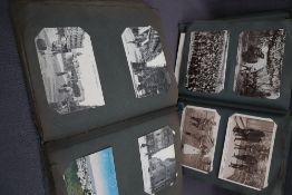 Two postcard albums comprising war related postcards, architecture, travel, comic, photographs,