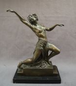 A bronze model of a semi naked maiden dancing, on a stepped base,