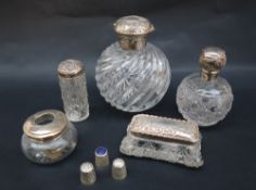 A Victorian silver topped and swirling glass scent bottle together with a smaller example two