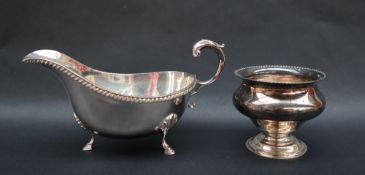 An Elizabeth II silver sauce boat with a gadrooned rim, C scrolling handle and shell capped feet,