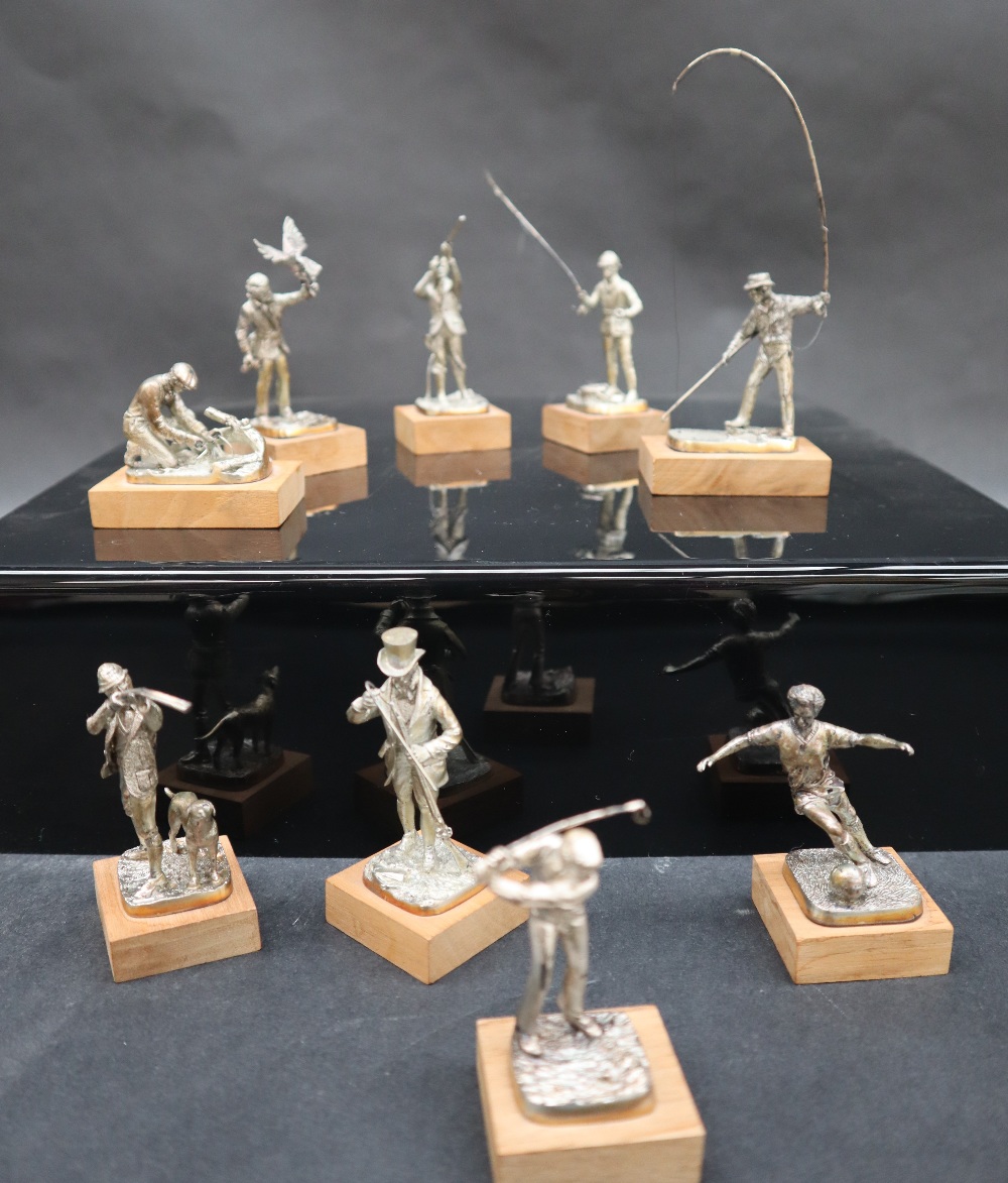 A set of nine Elizabeth II silver sportsmen figures including The Falconer, The Squire, The Poacher,