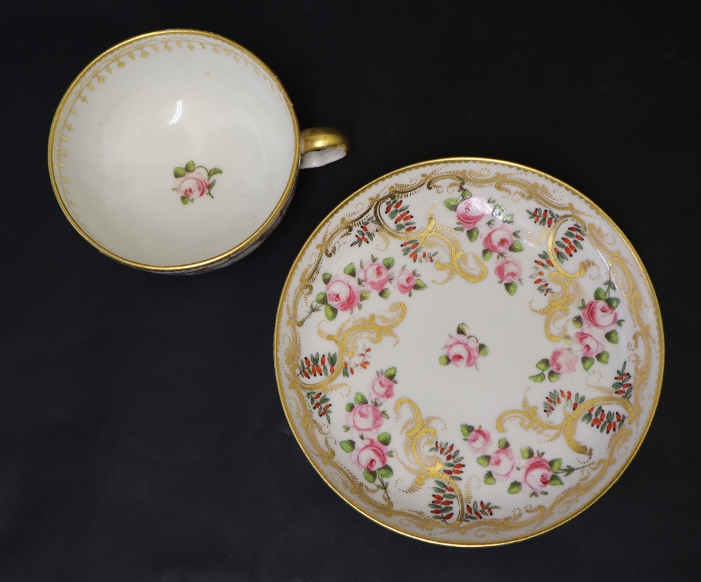 A Swansea porcelain tea cup and saucer painted with roses in a gilt garland border, 9. - Image 4 of 6