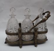 A Walker and Hall electroplated three bottle tantalus,