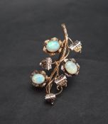 A yellow metal bar brooch of floral form set with three opals, marked 10k, 5cm long,
