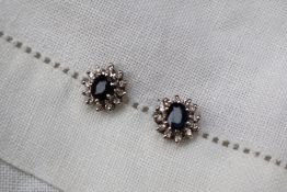 A pair of sapphire and diamond cluster earrings,