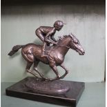 David Cornell Champion Finish A bronze statue of a racehorse and jockey on a rectangular marble