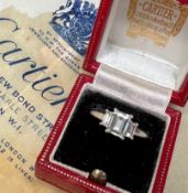 A Cartier diamond ring, set with a central emerald cut diamond approximately 6.