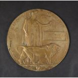 A World War I Memorial plaque (Dead Man's Penny) issued to Frederick Husband