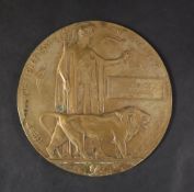 A World War I Memorial plaque (Dead Man's Penny) issued to Frederick Husband