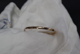 A 9ct yellow gold hinged bangle together with 9ct gold earrings, approximately 14.