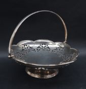 A George V silver swing handled cake basket of lobed form with a pierced rim,