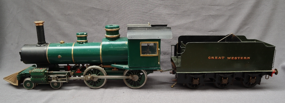 A live steam engine, in green livery together with a GWR tender in green, another tender,