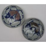 A pair of Japanese porcelain bowls decorated with a fish with crosshatched decoration, 21.