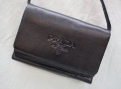 A Prada black leather clutch bag, the interior with card slots, zip purse, id windows etc,