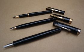 Two Sheaffer fountain pens together with a Parker ball point pen