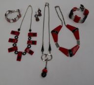 An Art Deco style red and black bakelite necklace together with two other necklaces,